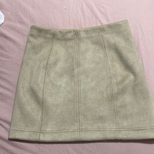 A mini skirt with a zip up back that has a light fur texture